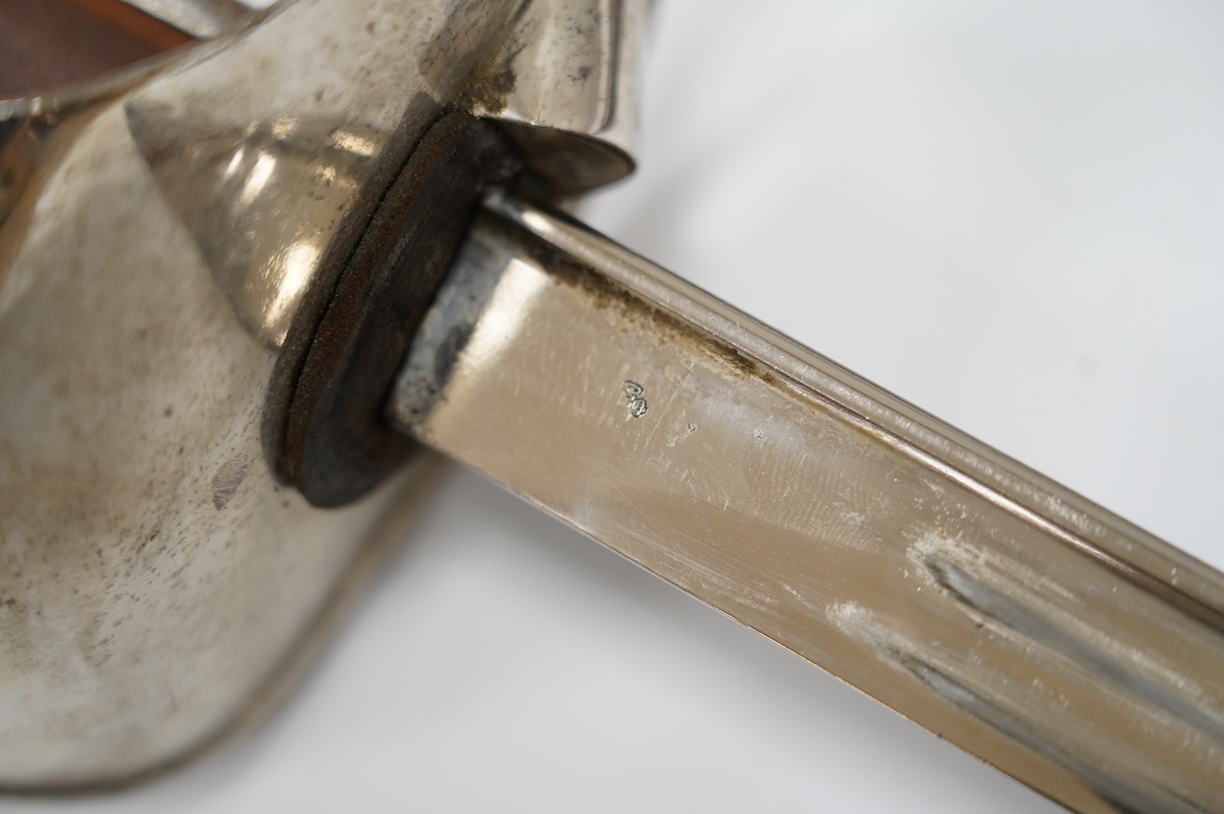 An Italian WWI cavalry trooper’s sword, pipe back blade, pierced guard, wooden grip, in its steel scabbard, blade 91cm. Condition - fair